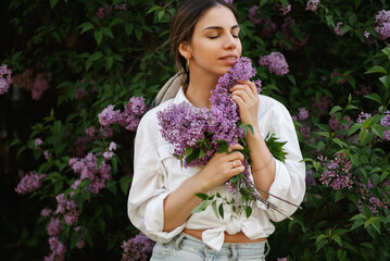 Woman Embraces Fragrant Lilac Blooms In Spring
