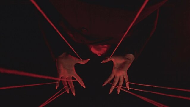 Fototapeta Complex Hand Movements in Red String Art Installation