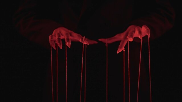Fototapeta Manipulative Red Hand Shadows Casting Dramatic Strings