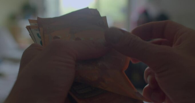 The video depicts a persons journey with wealth, starting with a paper covering their face. They express emotions tied to money, ending with food, symbolizing joy beyond materialism