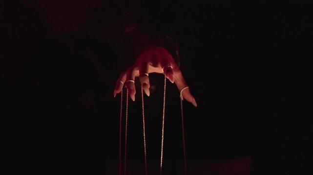 Mysterious Hand Manipulating Strings in Dark Atmosphere