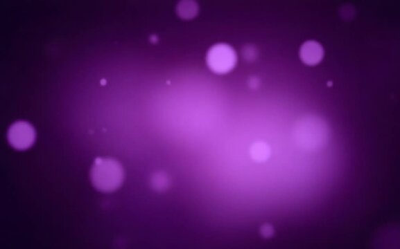 Blurred purple abstract background of bokeh and small round particles of energy magical holiday flying dots on a black background