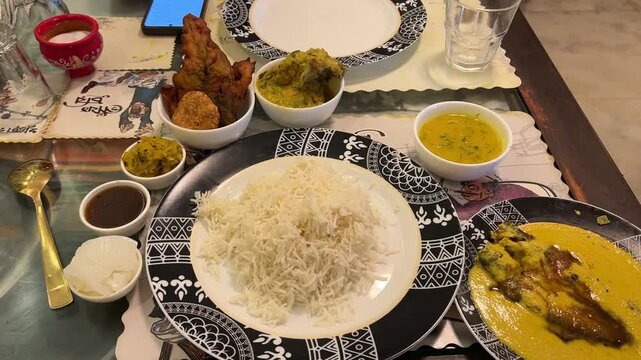 Traditional Bengali food platter with rice, mutton, chicken, fish, curd, fries served in Poila Boisakh in Kolkata