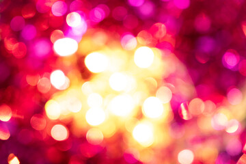 Festive blurred Christmas background, shining pink and yellow lights
