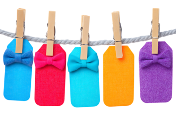 Colorful gift tags with bows hanging on a rope clothesline against a transparent background, creating a vibrant and celebratory presentation