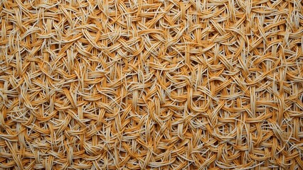 An intricate design of woven natural fibers displays a beautiful texture. The warm colors and patterns highlight craftsmanship and attention to detail in the weaving process.