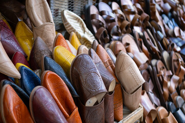Colorful Vibrant leather handmade Moroccan slippers, babouches for sale in traditional local souk, story heritage and authentic oriental craftsmanship, artisanal culture Morocco