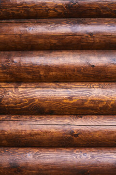 Wooden logs stacked in a rustic pattern, showcasing natural grain and texture in a cozy setting