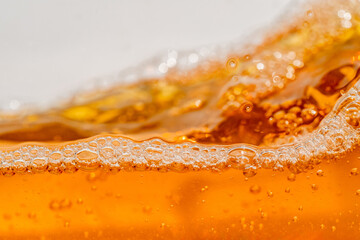Close up bright orange Oil or beer splash texture and nature waves, Beautiful waves curve and...