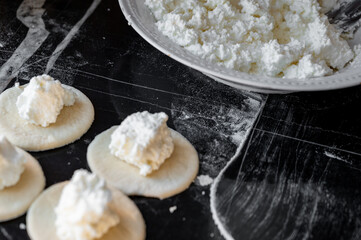 Cottage cheese filling placed on round dough wrapper, process of making dumplings