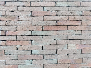 Captivating wall presents layers of beige brick, emitting natural, earthy aura that conveys sense of timeless warmth and rustic comfort throughout