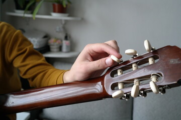 guy stringing guitar music lesson