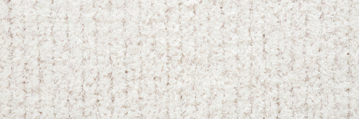 White soft hairy striped knitted fabric pattern background. Closeup. Wide banner. Top down view.