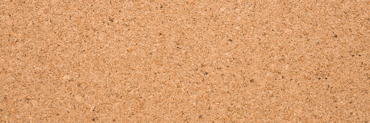 Light brown cork board background. Wide banner. Closeup. Empty place for text. Top down view.