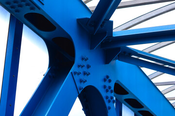 Close-Up Detail Of A Blue Painted Steel Girder Structure Of A Modern Bridge, Showing Bolted...