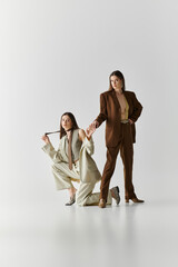 Stylish twin sisters showcasing their unique fashion sense in an artistic setting