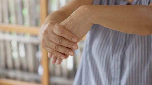 Close up of old woman stretching her forearms