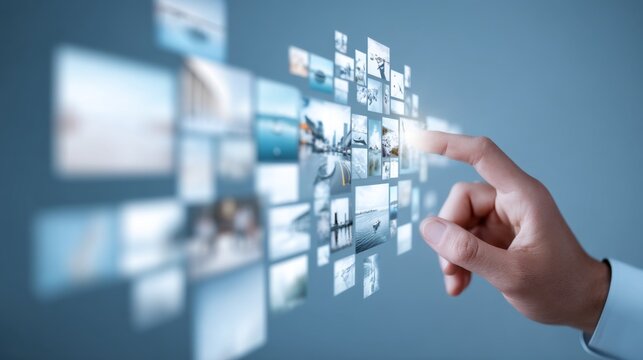 Hand interacting with floating images in a digital display, showcasing technology and innovation in the modern world