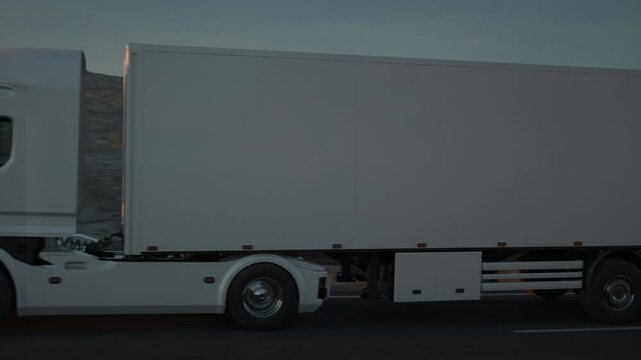 Side view of a white long distance semi truck with cargo trailer drives on a desert road into the sunset. Drone POV following the truck. 3d animation rendering.