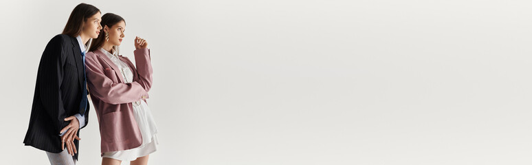 Stylish twin sisters share a moment of bonding while showcasing their unique fashion sense