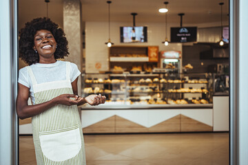 Smiling Baker Standing in Front of a Modern Bakery Interior