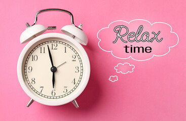 Alarm clock and speech bubble with words Relax Time on pink background