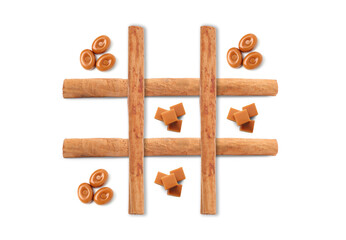Tic-tac-toe game made of hard toffee and caramel candies on white background, top view