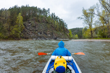 A skilled kayaker navigates serene river waters, surrounded by breathtaking landscapes, immersing...