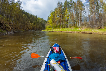 Fototapeta premium Experience a serene kayaking adventure that takes you through lush forests and beautiful landscapes, giving you the chance to explore the natural ecosystems while enjoying outdoor relaxation