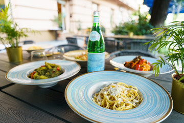 Italian pasta dishes served with sparkling water