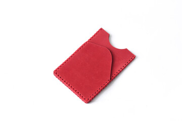 Close-up of a handmade red leather cardholder with intricate stitching along the edges, showcasing its smooth surface and craftsmanship.