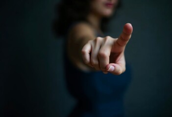 A close-up shot features a young woman with a finger pointing towards , the background is dark and blurred gradient.