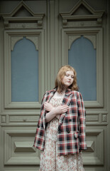 young beautiful woman on background vintage door