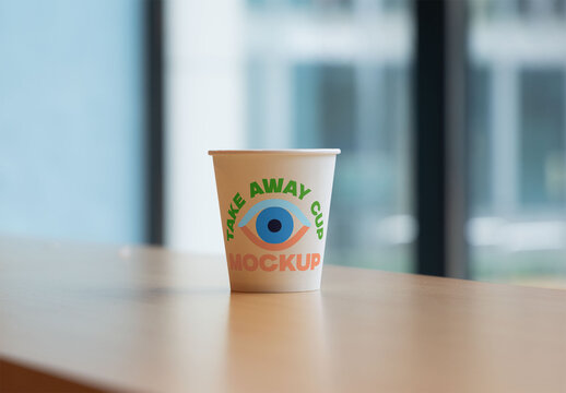 Simple takeaway cup mockup placed on a wooden surface.