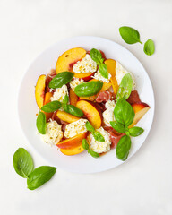 Peach Salad with Basil and Cheese on White Plate
