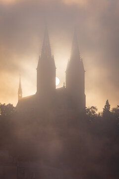 The Vysehrad basilica in the early morning fog and clouds in Autumn in UNESCO city site Prague.