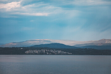 Cloudy and melancholic morning on the ferry to Vancouver. A moody seascape with calm waters, misty islands, and soft light capturing the quiet beauty of the Pacific Northwest.