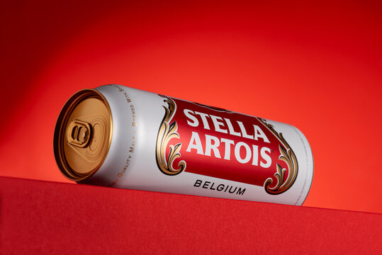 Lviv, Ukraine - May 15, 2025: Stella Artois lager beer in aluminum tin on red background