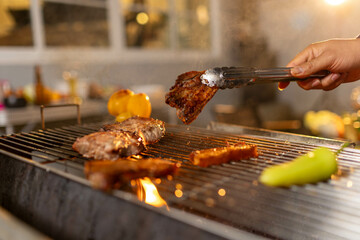 Juicy, tender steak sizzles over open flames on a rustic barbecue grill, with herbs and smoke enhancing the rich aroma of outdoor cooking.
