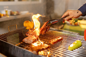 Juicy, tender steak sizzles over open flames on a rustic barbecue grill, with herbs and smoke...