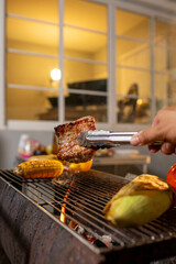Juicy, tender steak sizzles over open flames on a rustic barbecue grill, with herbs and smoke enhancing the rich aroma of outdoor cooking.
