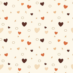 A seamless pattern of hearts and crosses in various shades of brown and orange on a cream background. The hearts are of different sizes and the crosses are small and delicate. 