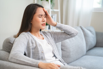 Young Asian females feeling dizzy after standing too fast, have symptoms of low blood pressure