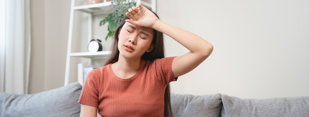 Young Asian females feeling dizzy after standing too fast, have symptoms of low blood pressure