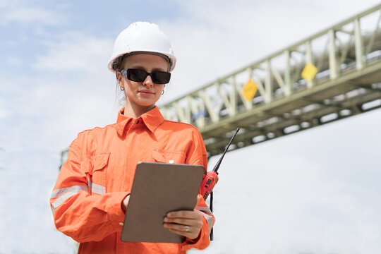 Petroleum refinery piping network system. Network of pipes, valves, pumps, mechanisms deliver natural gas. Petrochemical engineer inspecting, maintain, repair gas lines in natural gas separation plant