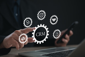 Businessman interacting with virtual CRM gears on screen, representing customer relationship management, business integration, marketing strategy, team collaboration, data analysis, and client success