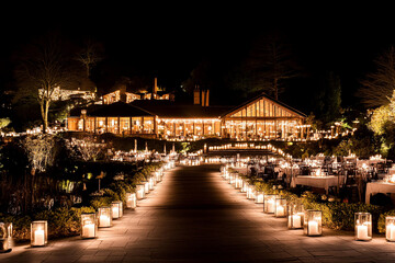 Garden illuminated with countless fairy lights and flickering candles during a serene night event