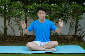 man practicing yoga outdoors in a lush garden setting