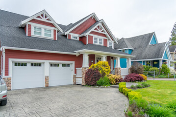 Garage door in luxury house with trees and nice landscape in Spring in Vancouver, Canada, North America. Day time on April 2025.