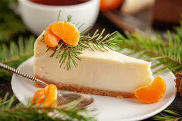 Tangerine cheesecake on a plate in Christmas decor